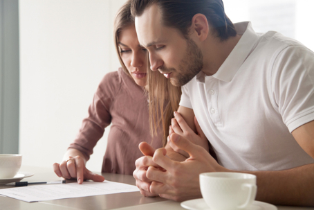 Image of a couple reviewing a document together